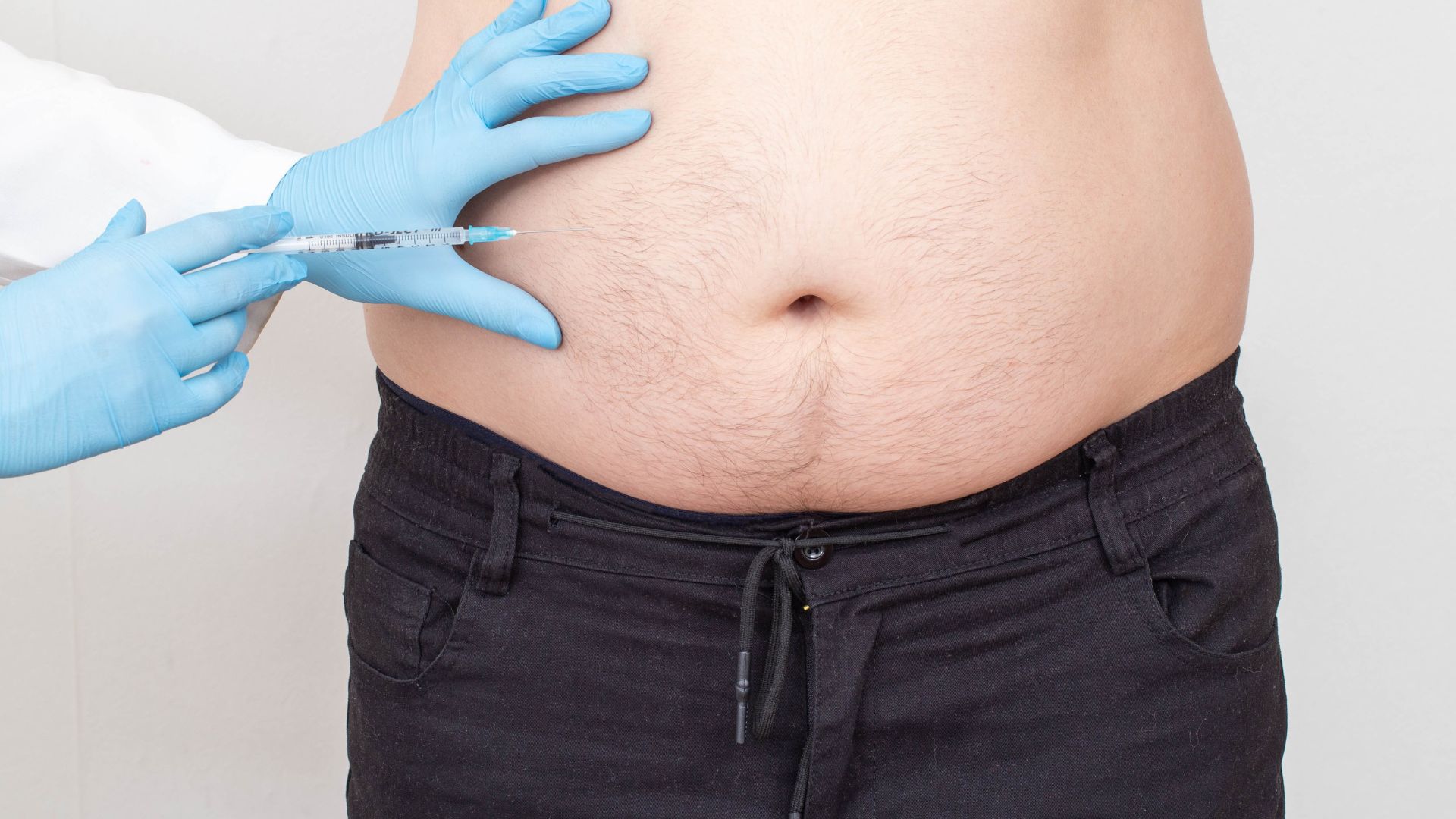 Fat Dissolving Injections in Dubai - Doctor Injecting Lipolytic Injections to Man's Body